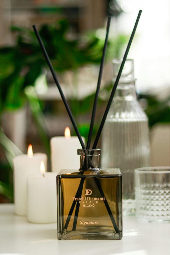Fratelli Diamanti signature fragrance diffuser surrounded by candles, ideal for relaxation.